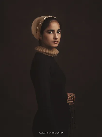 Caught somewhere between a painting and a dream. This portrait is a modern interpretation of a classical style, with the ruff collar and pearl-studded cap.
