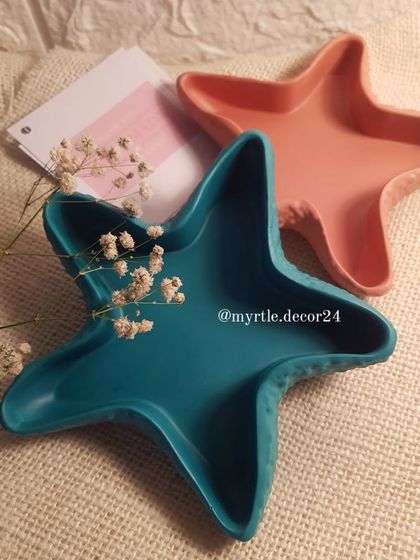 Two of our starfish trinket dishes in solid teal and warm pink, perfect for adding a pop of color to your space.