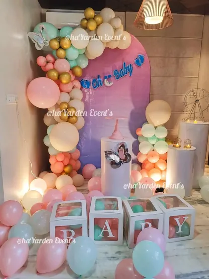 The main decor for the 'Mom to Be' party, featuring a pastel balloon garland, 'BABY' blocks, and an 'Oh Baby' banner.