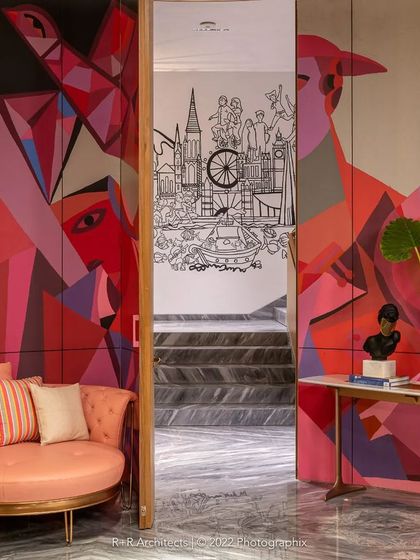 The entrance to the 'Clandestine House' project, where a vibrant, abstract mural in shades of red and pink greets visitors. This piece sets the stage for the narrative art experience that unfolds within.