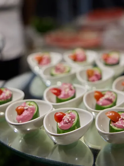 Cucumber cups filled with a creamy beetroot hummus and topped with a cherry tomato. This is a refreshing, healthy, and elegant appetizer option for any occasion.