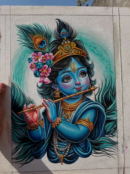 Holding up the finished Kanha painting. I love how the colors look in the natural light.