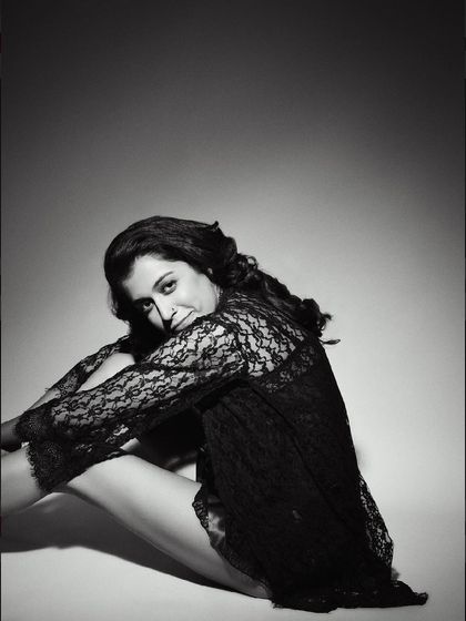 A delicate black and white boudoir-style portrait. The lace and her soft expression create a feeling of gentle intimacy.