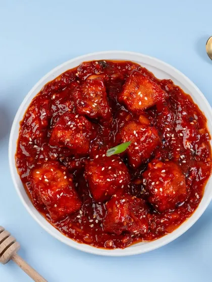 A top-down shot of honey garlic paneer. This angle is great for showcasing all the ingredients in the bowl and creating a clean, graphic composition.