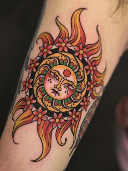 A vibrant, traditional-style sun tattoo, chosen by our client Mike as the perfect, soulful souvenir from his trip to India.