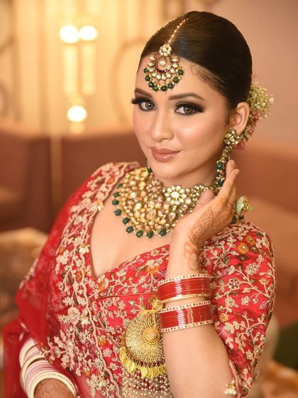 A close-up showcasing the large earrings and tikka from the bridal set, highlighting the detailed craftsmanship that makes my jewellery stand out.