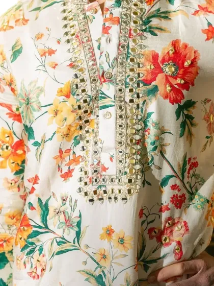 A close-up of the mirror-work neckline on the floral kurta.