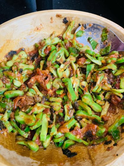 This is a simple chutney made from bitter gourd, which we call 'Asangba'. It's mixed with roasted tomatoes and chillies to balance the bitterness.