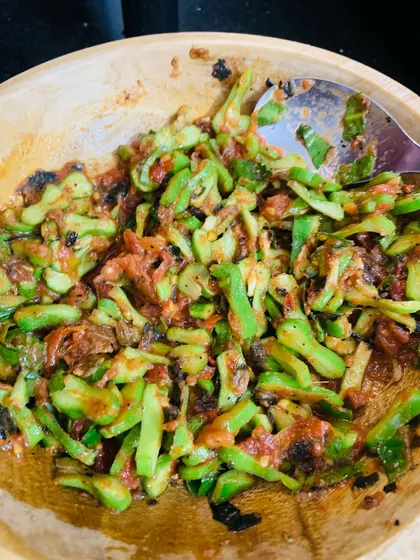 This is a simple chutney made from bitter gourd, which we call 'Asangba'. It's mixed with roasted tomatoes and chillies to balance the bitterness.
