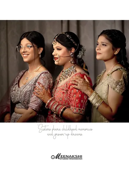 A heartfelt, candid moment between the bride and her sisters. This photo is all about capturing the genuine emotions and shared history that are so much a part of a wedding day.