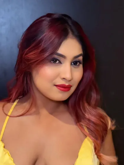 Party glam for this lovely woman. A classic look with bold, winged eyeliner and a vibrant red lip.