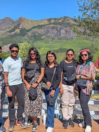 Posing for a photo against the stunning backdrop of the Western Ghats mountain range in Munnar.