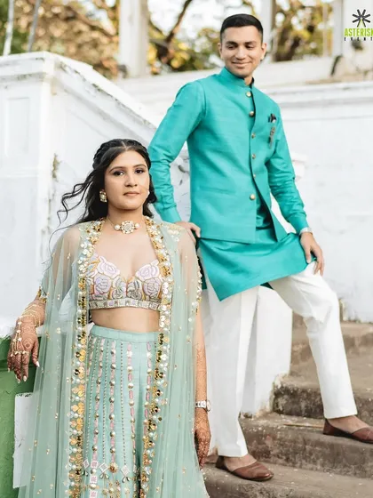 A beautiful portrait of the couple at their Mehendi, showcasing their coordinated pastel outfits and the love between them.