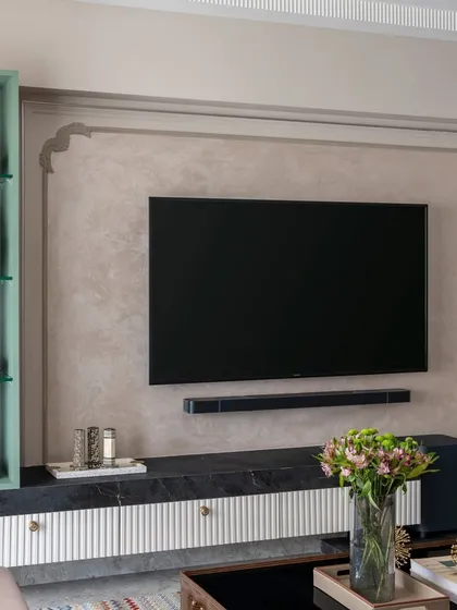 This sleek TV unit offers ample storage while maintaining a light footprint. The combination of a low-height console and a vertical display shelf is a stylish and functional solution for modern homes.