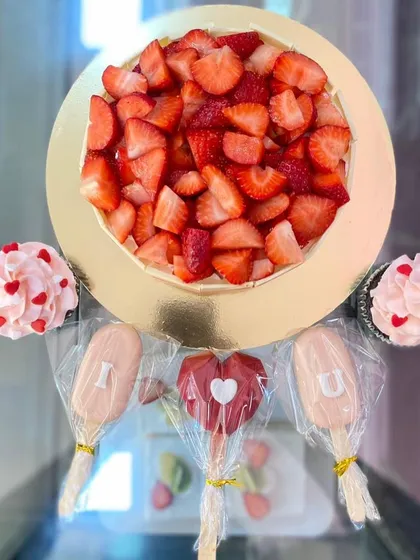 A Valentine's Day special, featuring a fresh strawberry cake, "I ❤️ U" cakesicles, and matching cupcakes.