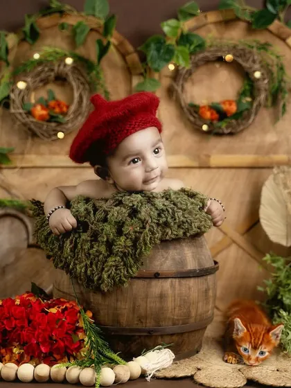 This 2-month-old looks so charming with his red beret in this rustic, woodland-themed setup.