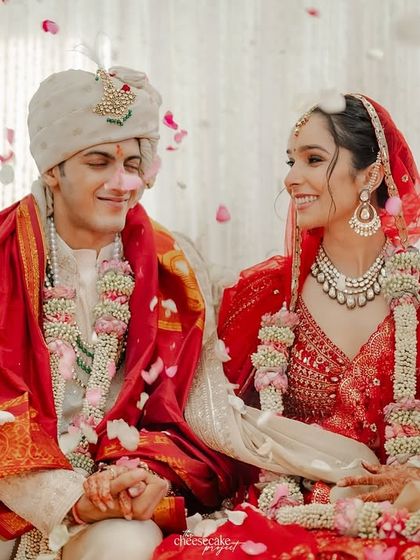 A candid moment of the couple sharing a laugh while seated at the mandap.