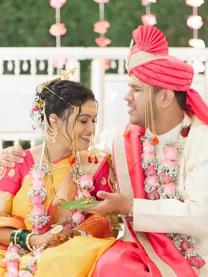 The couple sharing a lighthearted moment during their wedding rituals.