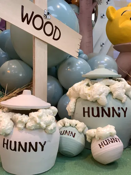 Custom-made "Hunny" pots, overflowing with "honey," were a key decorative element in the Winnie the Pooh theme.