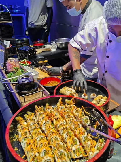 Our chefs meticulously prepare fresh sushi rolls at a live station for the exclusive Mercedes EQ launch. Offering high-end options like this demonstrates our commitment to providing diverse, premium cuisine for sophisticated corporate events.