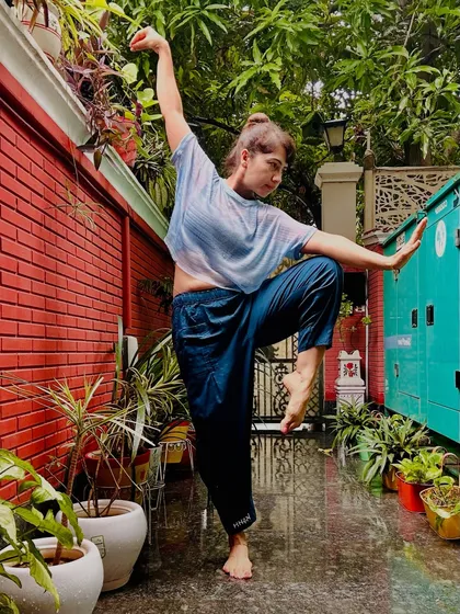 This pose, which I call "White Crane Energy," embodies fierce balance in the midst of chaos. It is a moment of finding strength in softness and stillness in motion, a perfect reset for the mind and body.