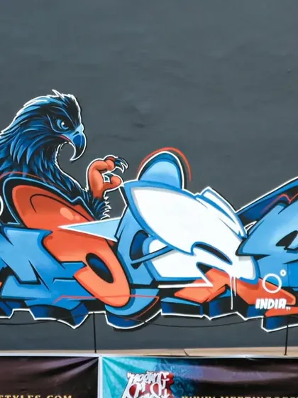Taking my art global. This piece, featuring a fierce eagle, was my entry for the Meeting of Styles graffiti festival in Indonesia. It's an example of how I blend characters and letters for international events, sharing wall space with artists from around the world.