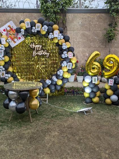 The complete casino-themed setup with a gold foil backdrop, perfect for a fun and unique garden party.