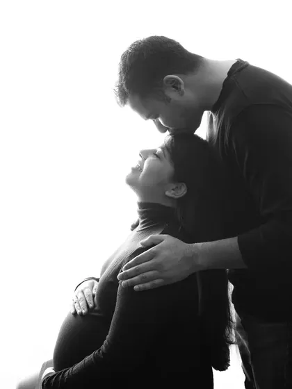 A gentle forehead kiss. This black and white photo feels so intimate and real, capturing a quiet moment of love and happiness between the couple.