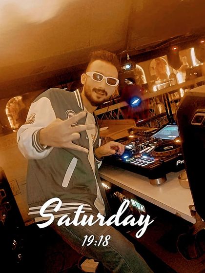 A Saturday night pose behind the Pioneer decks. I'm ready to deliver a healing dose of music and energy.