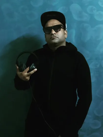 A cool, understated look in a black hoodie. This shows a more relaxed side, but still ready to hit the decks at a moment's notice.