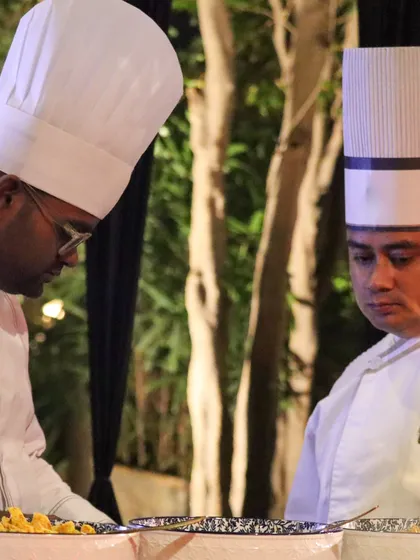 Two of our chefs working in unison, a picture of the collaboration and shared passion that defines our kitchens.