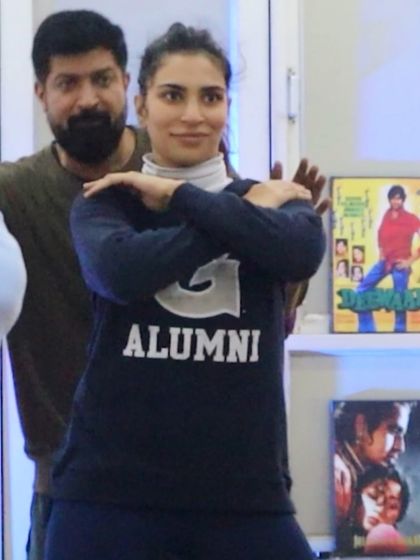 A close-up of me helping a student with her arm placement. Details matter in dance.