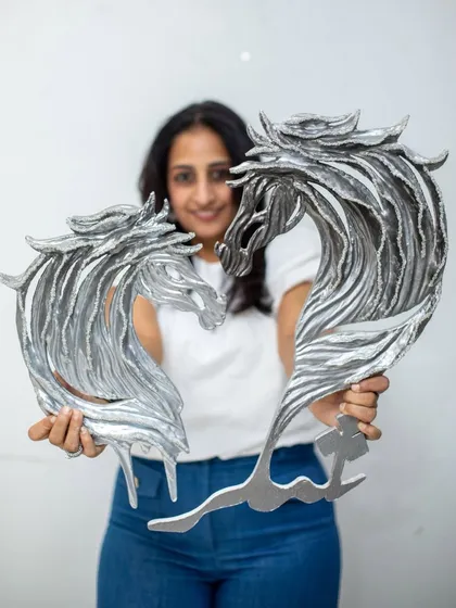 My art is about capturing emotion in physical form. Here, I'm holding the "Eternal Horses" sculptures, which are crafted from upcycled paper and embellished with rough diamonds. These pieces embody a blend of untamed strength and refined luxury, perfect for making a statement.