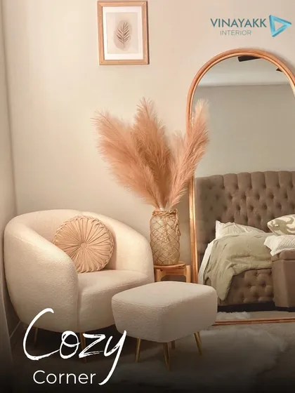 I love creating cozy corners for relaxation. This setup features a plush armchair and ottoman, a full-length arched mirror that reflects the room, and pampas grass for a touch of soft, natural texture. It's the perfect nook to unwind.