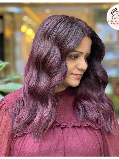 A side view of the bold grape wine color, with soft waves that enhance the rich, vibrant hue.