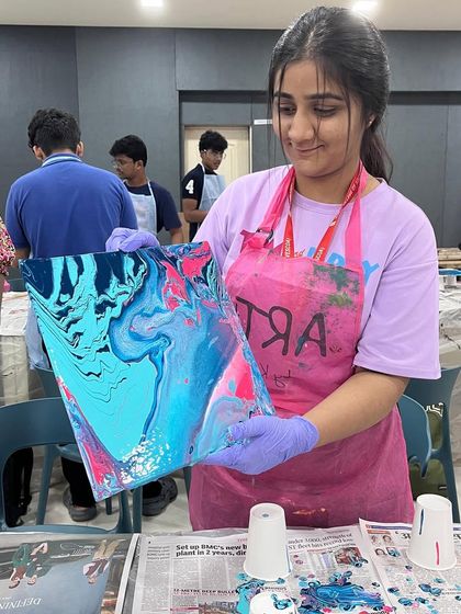 Another happy student from the VESCOA college workshop, showing off her vibrant pink and blue fluid art piece. The energy and enthusiasm of the students was truly infectious.