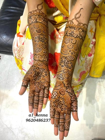 This full-arm bridal design features beautiful floral bands and intricate patterns, perfect for a bride who wants a statement look.