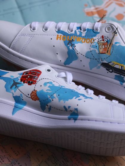 For the wanderer in you. This pair of Adidas Stan Smiths is dedicated to a client's four favorite cities, with little icons representing each place on a world map.