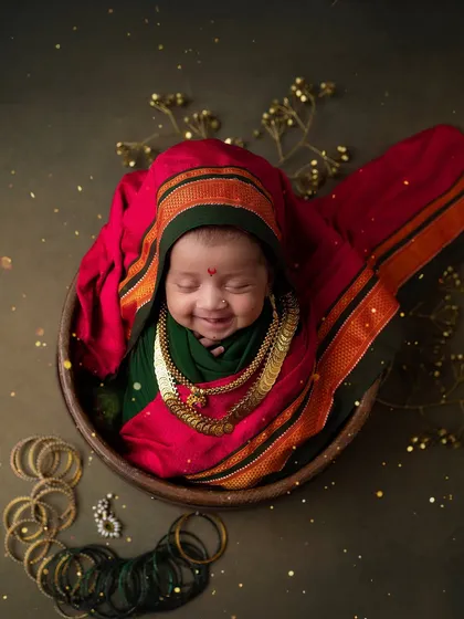 A full portrait of our little Ganpati devotee, surrounded by traditional props. The details in this setup help tell a beautiful cultural story.