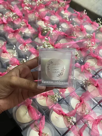 A large order of our tea light box candles, ready to be gifted. The custom sticker and real flower detail make them extra special.