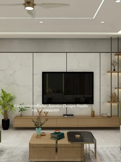 The TV unit in this 3BHK is designed to be clean and minimalist. A marble-finish back panel is paired with a floating wooden console and open shelving, providing a stylish yet uncluttered look that incorporates greenery for a fresh feel.