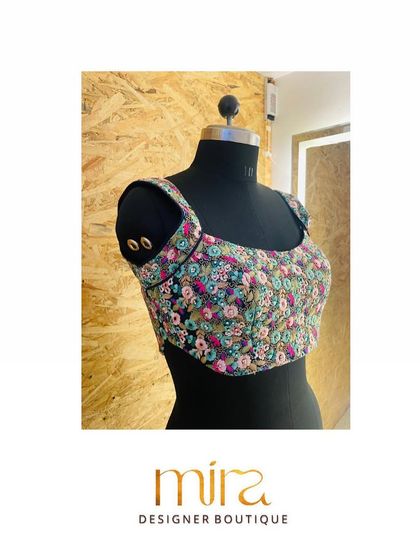A full front view of the multi-color floral sequin grid blouse on a mannequin. This piece is a celebration of color and texture, perfect for a bride who wants a fun yet glamorous look.