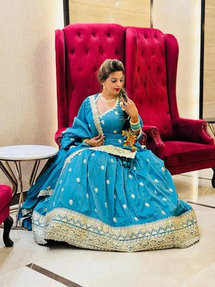 A beautiful blue sharara suit with gold embroidery. This is a comfortable yet regal rental option, perfect for a mehendi, sangeet, or as a wedding guest.