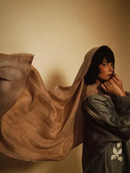 A fine art portrait for House of Wandering Silk, where the fabric itself becomes a dynamic part of the composition, flowing around the model.
