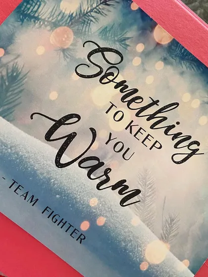 A sweet note saying 'Something to keep you warm' from Team Fighter, which I included in the winter essentials kits for the crew.
