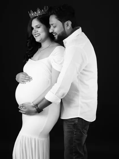 A joyful black and white portrait. This couple shares a laugh, creating a candid and heartwarming image of their journey together.