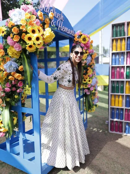 Posing in a fun, colorful photo booth at the Haldi venue. The decor was amazing and provided so many great photo opportunities.