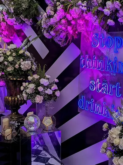 This fun neon sign, with its "Stop thinking start drinking" message, added a playful and cheeky touch to the cocktail bar area, encouraging guests to let loose.
