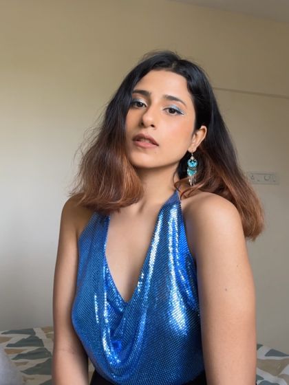 A confident look with bright blue eyeliner.