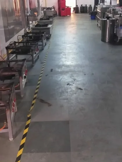 Another perspective of our rental kitchen, showing the line of gas ranges and the ample floor space available for food preparation and movement.